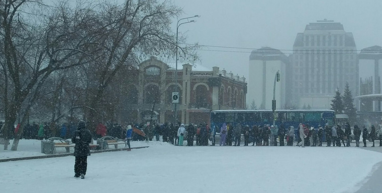 Болельщики, среди которых было много детей, стояли в очереди под мокрым снегом