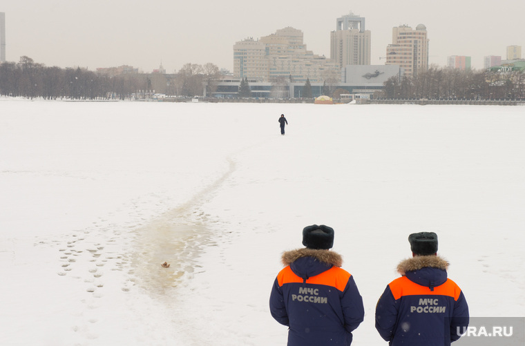 Сотрудники МЧС наблюдают за людьми, переходящими Исеть по льду. Екатеринбург