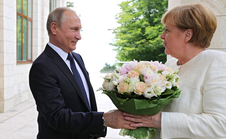 Путин подарил Меркель букет роз и фезалий