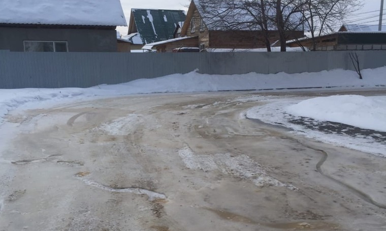 Желтый лед из канализационных стоков образовался на дороге по улице Ленина в селе Кетово