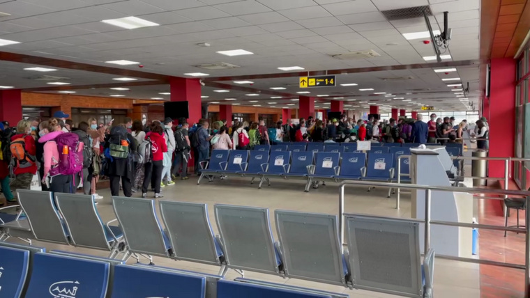 Российские туристы стоят в очереди на посадку в самолет в Непале