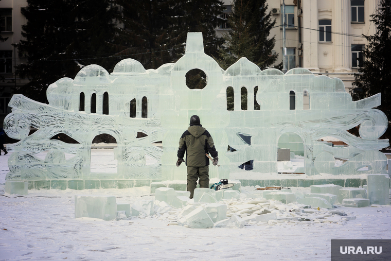 Рабочие вырезают фигуры для ледяного городка