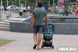 Мужчина гулял на площадке с коляской и старшим сыном