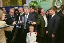 Ахмат Кадыров (в центре) дает интервью после голосования, справа - Рамзан Кадыров