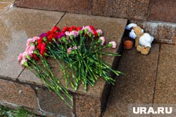 У памятника в память о погибших детях часто оставляют цветы, игрушки и свечи