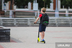 Types of the city.  Kurgan, child, children, unsupervised child, restrictive tape, scooter