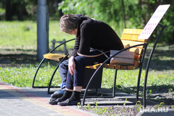 Violation of the regime of self-isolation by residents of the city.  Kurgan, shop, unemployment, fatigue, sadness, park, summer, woman, bench
