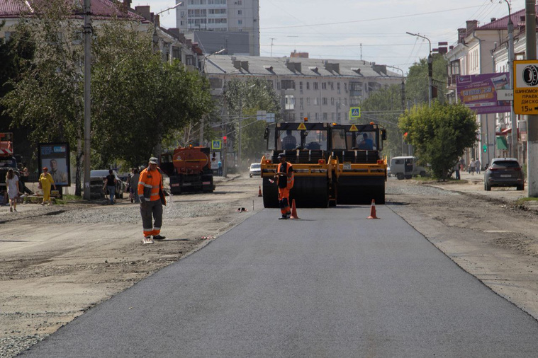 После выравнивающего слоя подрядчики кладут полосы асфальта
