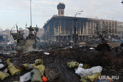 Maidan.  Ukraine.  Kyiv, Maidan, unrest, revolution, battlefield, burning, war, devastation, burnt building, monument to the founders of Kyiv, house of trade unions