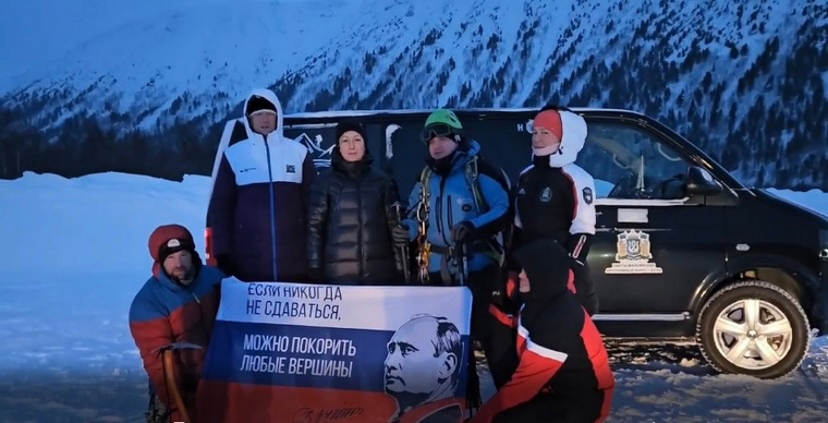 Путешественники из ХМАО поднялись на вершину горы Неройка, где развернули российский флаг с изображением президента РФ Владимира Путина